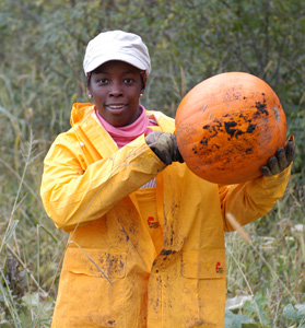 woman holding up pumpkin